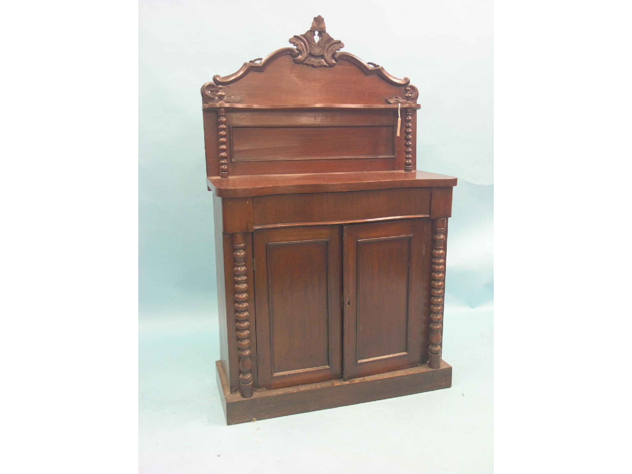 Appraisal: A Victorian mahogany chiffonier raised panel-back with over-shelf and scroll