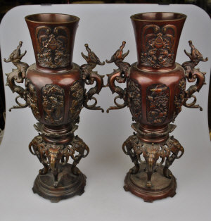 Appraisal: A pair of Chinese bronze vases with dragon side handles