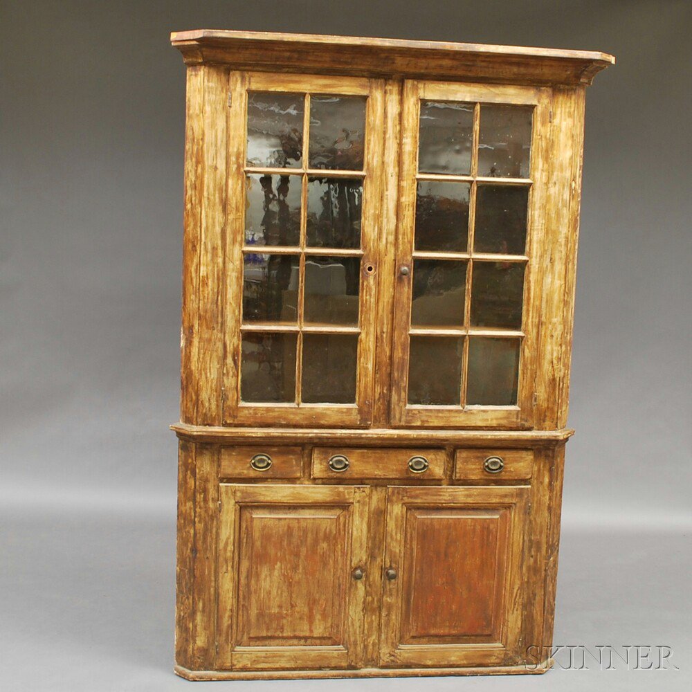 Appraisal: Paint-decorated Glazed Two-part Corner Cupboard the overhanging molded cornice over