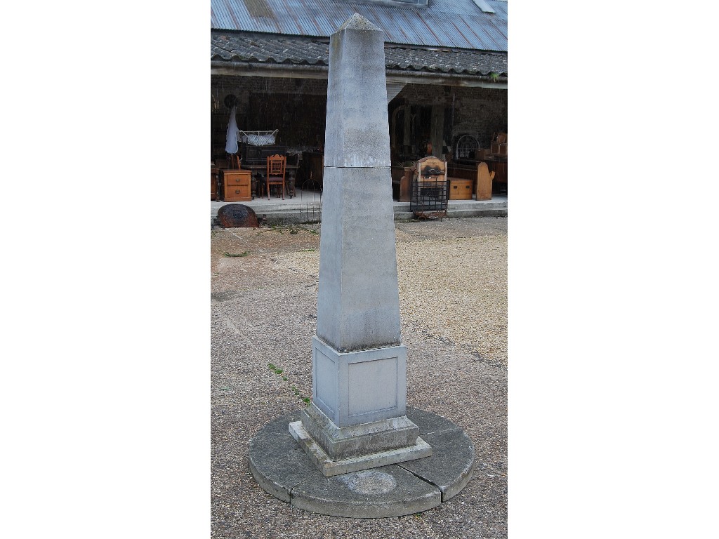 Appraisal: A cast stone obelisk of tapering form on circular base