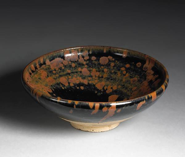 Appraisal: A Cizhou type black glazed stoneware bowl with russet splashes