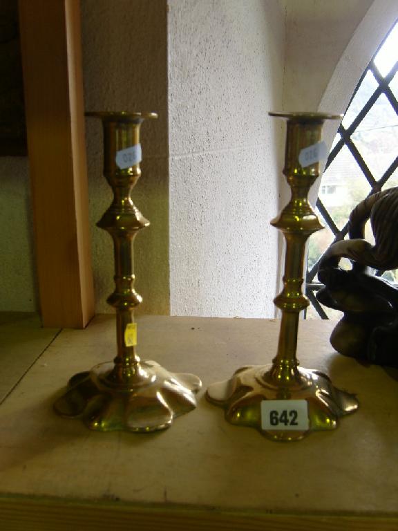 Appraisal: A pair of Georgian brass petal base candlesticks with simple