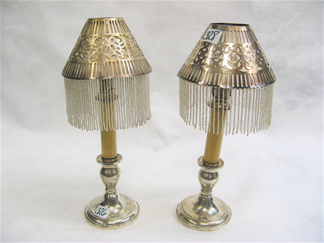 Appraisal: PAIR OF AMERICAN STERLING SILVER CANDLE LAMPS having pierced silver