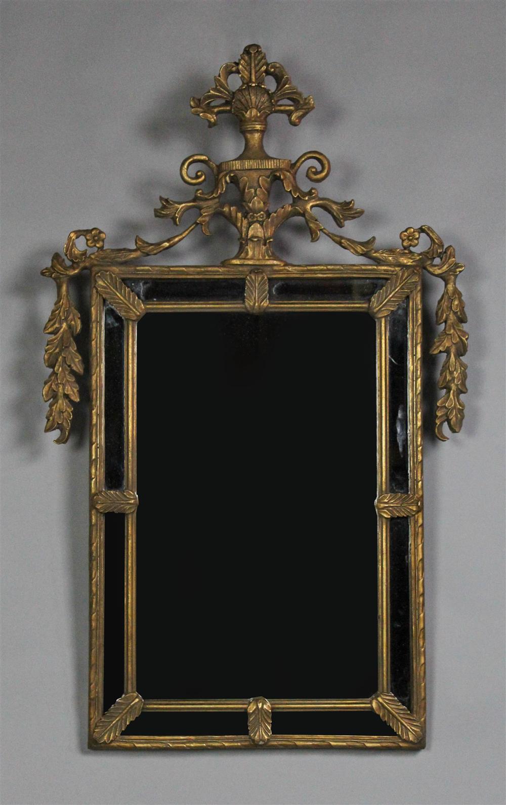 Appraisal: CONTINENTAL NEOCLASSICAL STYLE GILT BRASS MIRROR the shaped crest molded