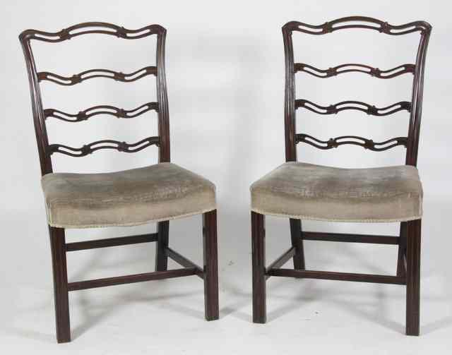 Appraisal: Four mahogany pierced ladder back single chairs with upholstered seats