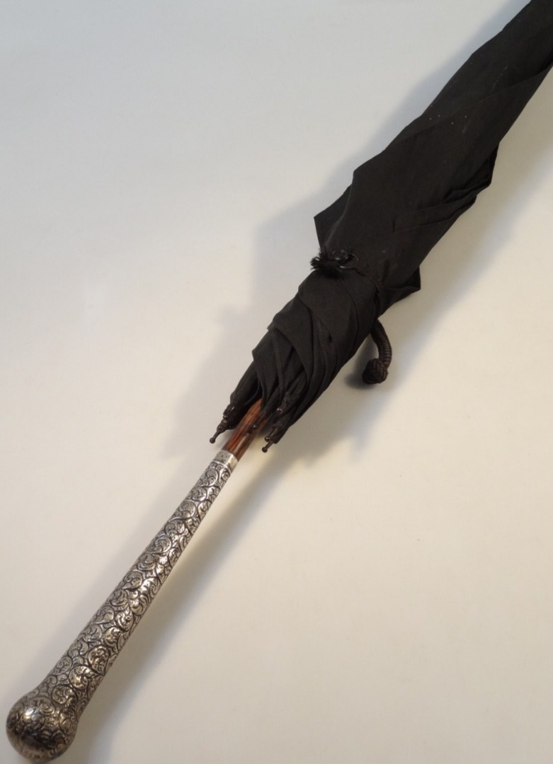 Appraisal: A George V silver handled umbrella with bamboo cane stem