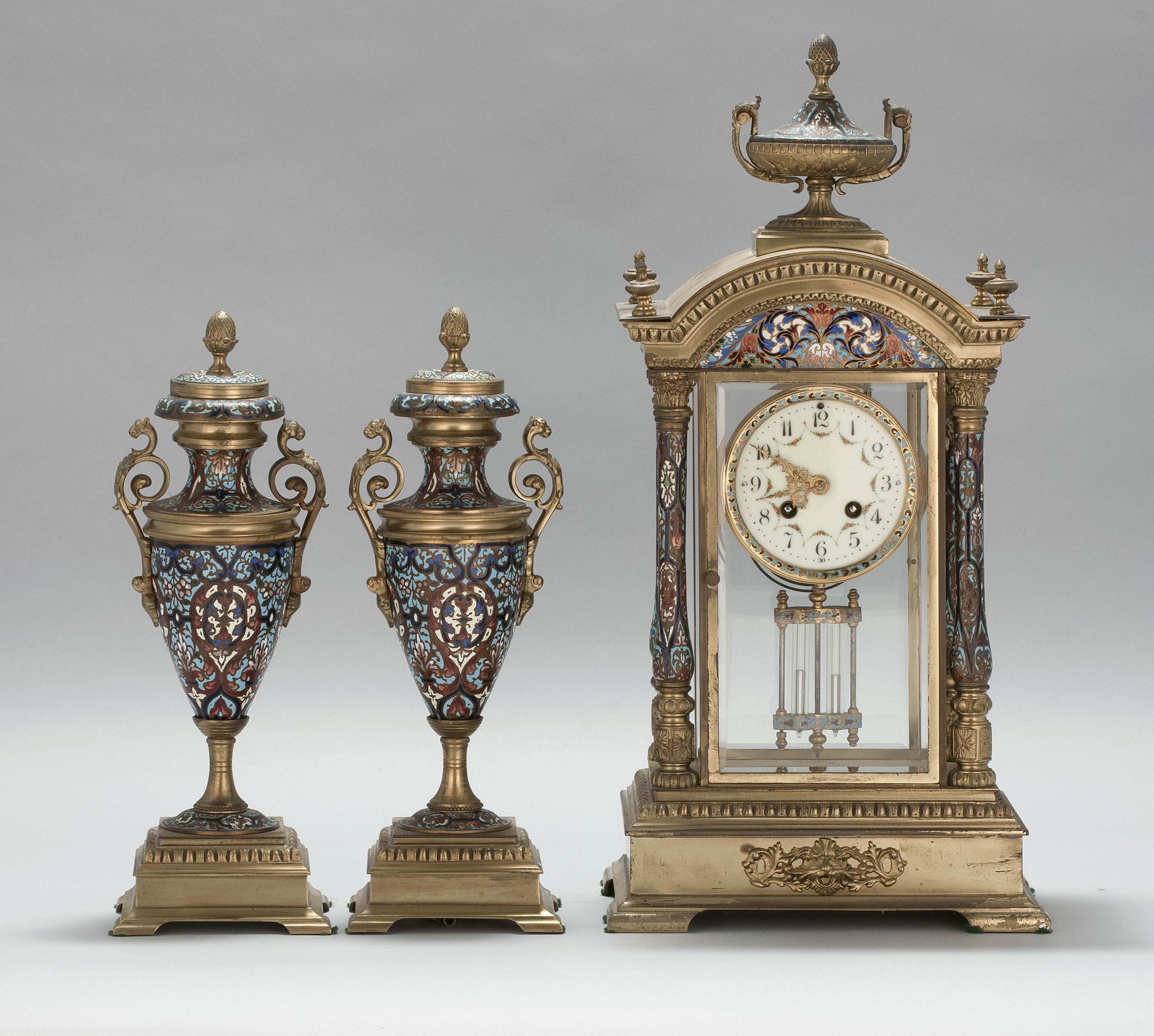 Appraisal: THREE-PIECE FRENCH CHAMPLEV CLOCK GARNITURE Early th CenturyEach piece decorated