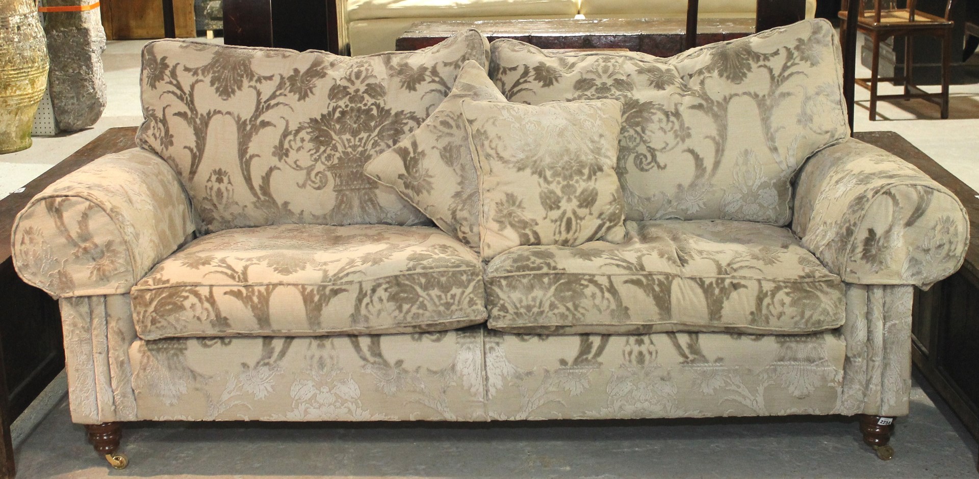 Appraisal: A th century sofa with floral print upholstery on turned