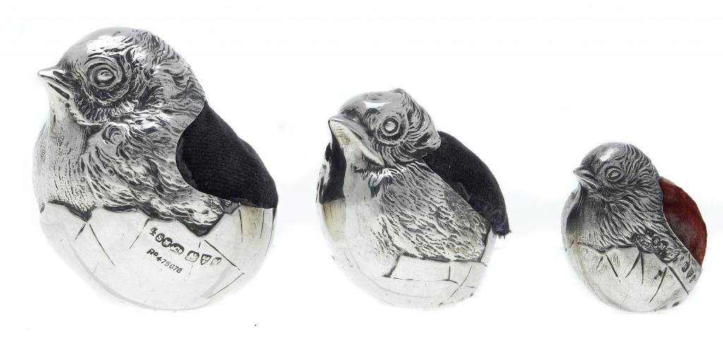 Appraisal: SAMPSON MORDAN THREE SILVER NOVELTY PIN CUSHIONS in the form