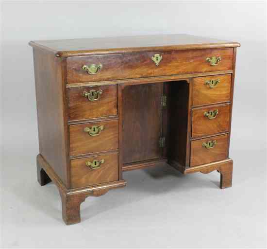 Appraisal: A George III mahogany kneehole desk with an arrangement of