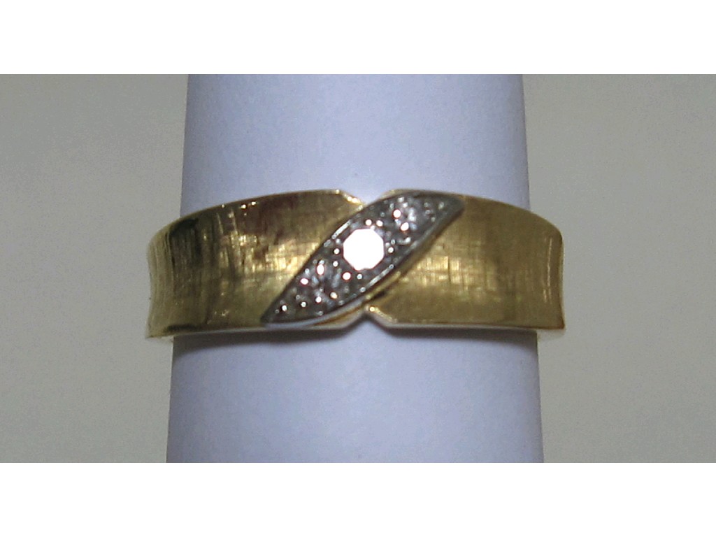 Appraisal: Eighteen carat gold three stone diamond set matt finish band