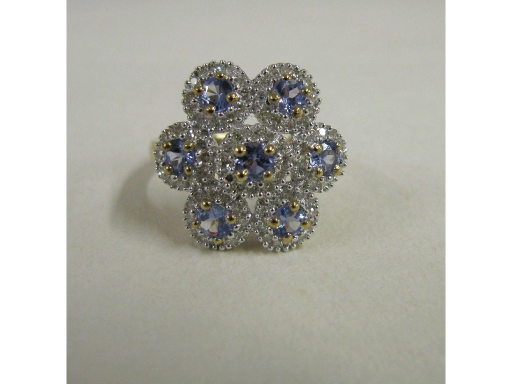 Appraisal: Nine carat gold tanzanite and diamond cluster ring