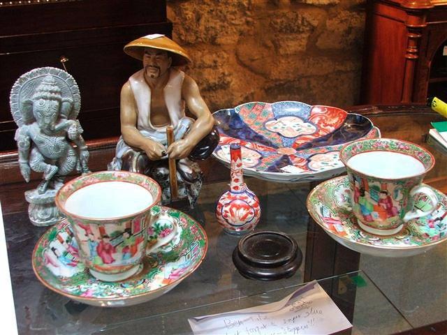 Appraisal: A PAIR OF CANTONESE CUPS AND SAUCERS decorated with panels