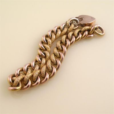 Appraisal: A ct gold curb link bracelet Half engraved with foliate