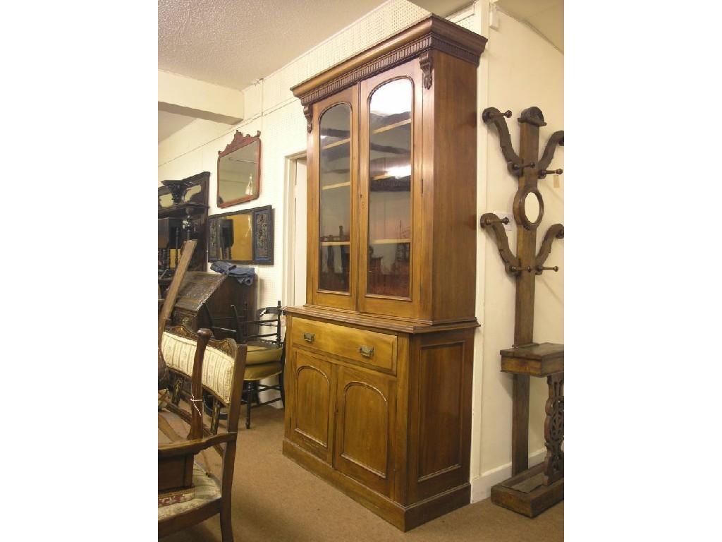 Appraisal: A Victorian walnut tall bookcase dentil pediment above a pair