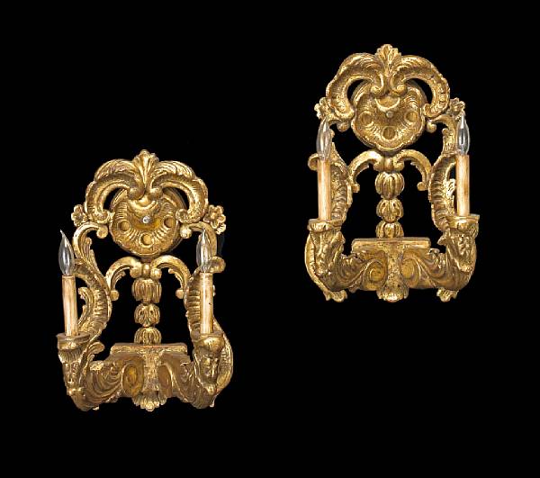 Appraisal: A pair of Baroque style giltwood two light wall lights