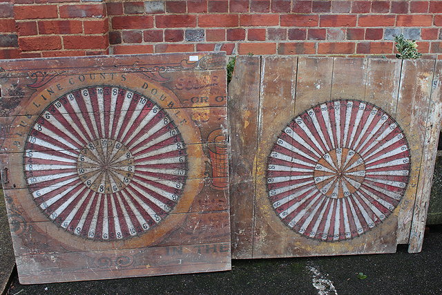 Appraisal: TWO VICTORIAN FAIRGROUND PAINTED WOOD DART BOARDS with faded decoration