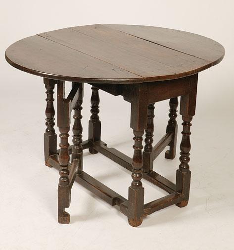 Appraisal: A CHARLES II OAK DROP FLAP DINING TABLE the oval