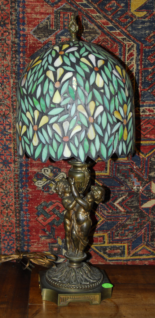 Appraisal: CONTINENTAL GILT METAL FIGURAL LAMP with a leaded glass shade