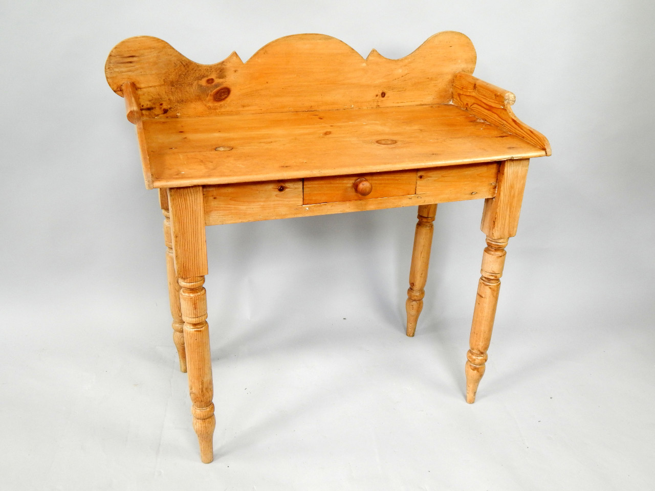 Appraisal: A Victorian pine washstand with a shaped galleried back and