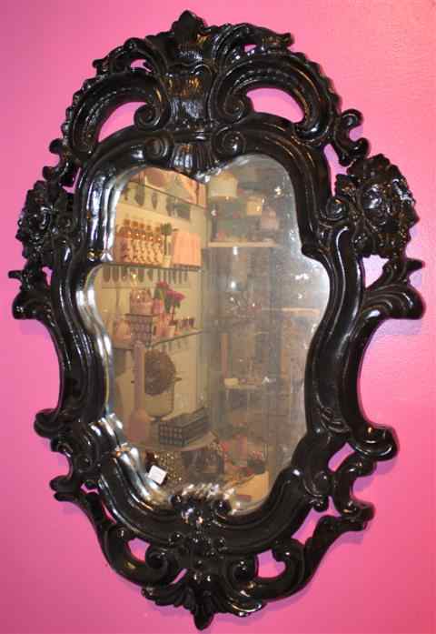 Appraisal: VICTORIAN STYLE EBONIZED MIRROR the shaped mirror plate within a