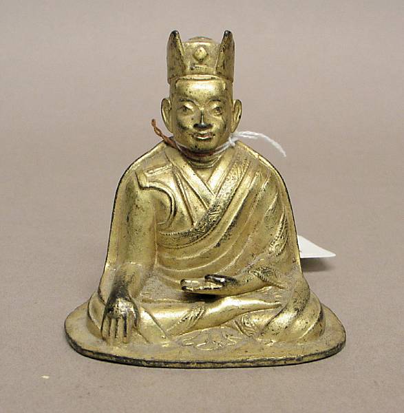 Appraisal: A Tibetan miniature bronze figure of a lama with cold