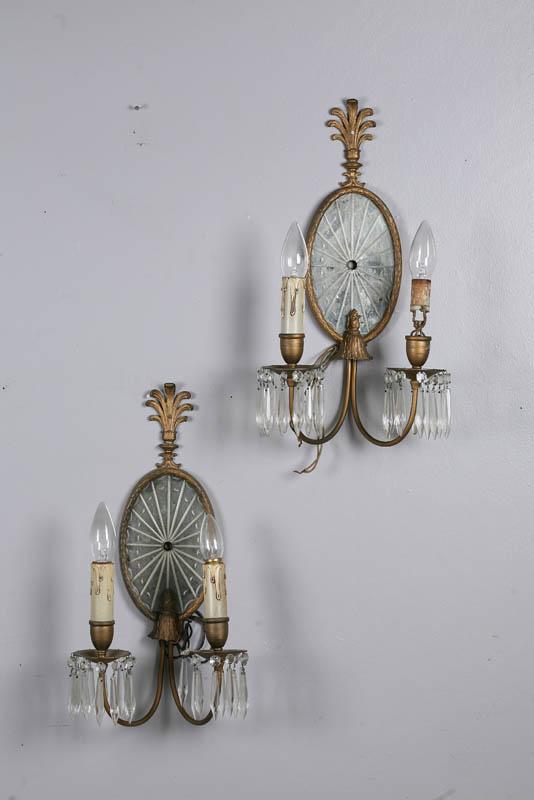 Appraisal: FOUR WALL SCONCES American th century white metal Oval mirrored