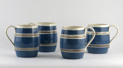 Appraisal: Four barrel-shaped mochaware mugs printed with two bands of a