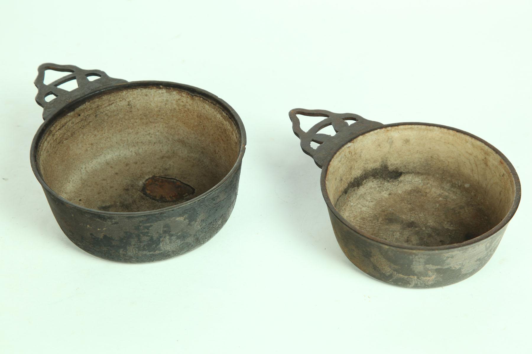 Appraisal: TWO CAST IRON PORRINGERS American th century One marked ''Clark's