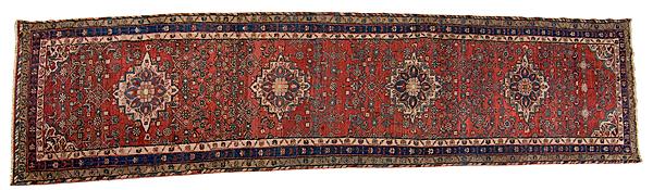 Appraisal: HAMADAN RUG RUNNER Persian ca s red ground spandrels and