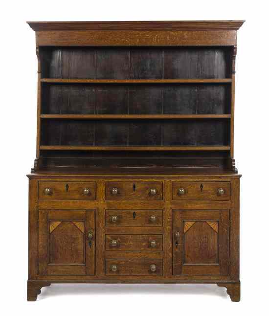 Appraisal: A Welsh Oak Cupboard having a molded cornice over the