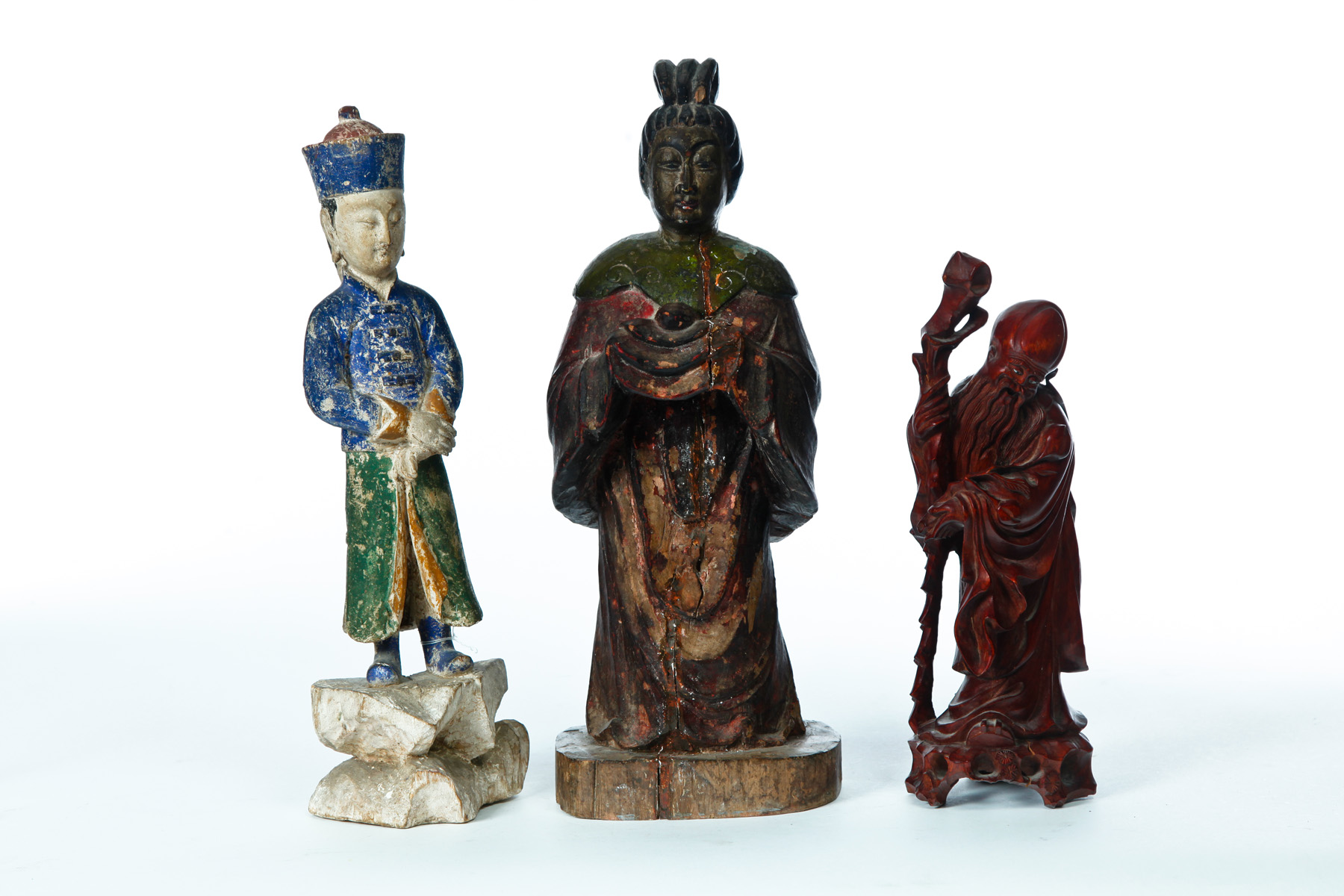 Appraisal: THREE ASIAN CARVED WOODEN FIGURES Twentieth century Two Chinese officials