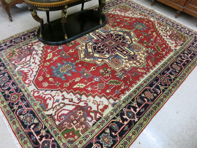 Appraisal: HAND KNOTTED ORIENTAL CARPET Persian Serapi design on red ground