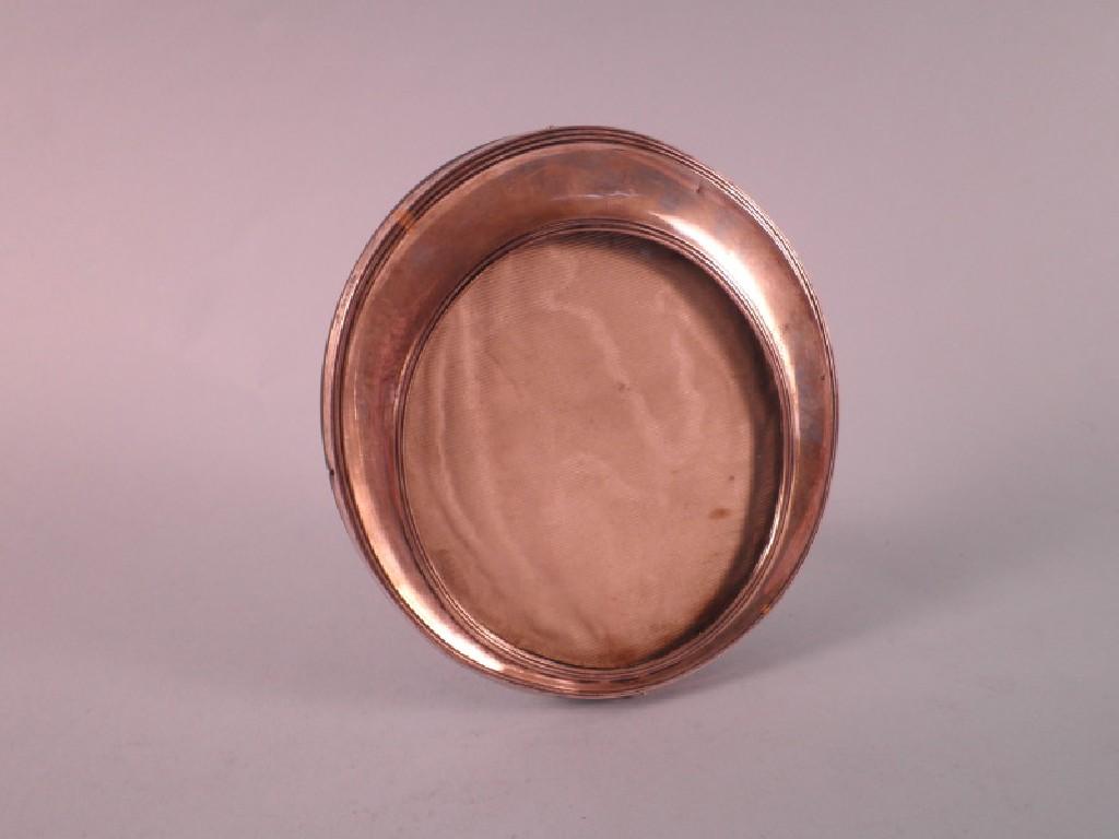 Appraisal: A silver mounted oval photograph frame with a reeded border