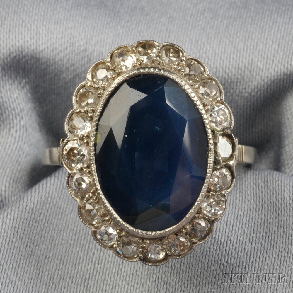 Appraisal: Sapphire and Diamond Ring France bezel-set with an oval-cut sapphire