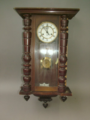 Appraisal: A Continental wooden cased regulator type wall clock the case