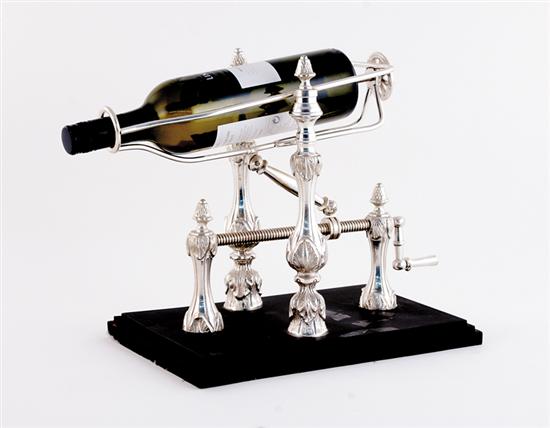 Appraisal: Silverplate wine cradle on stand frame holds bottle with lowering