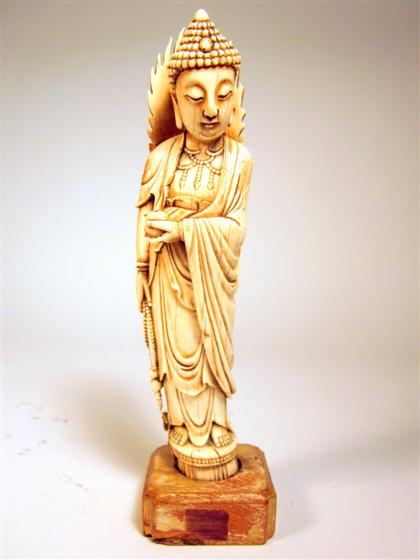 Appraisal: Chinese marine ivory model of QuanyinStanding surmounted by flame halo