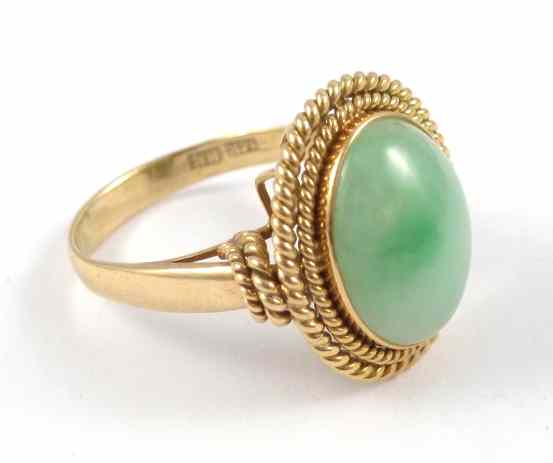 Appraisal: JADE AND YELLOW GOLD SOLITAIRE RING k gold with a