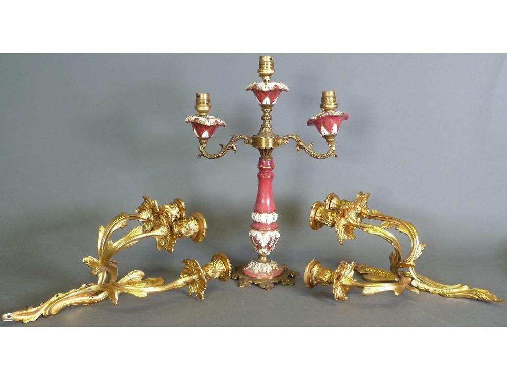 Appraisal: GILT METAL MOUNTED TWO BRANCH PORCELAIN TABLE LAMPS claret with