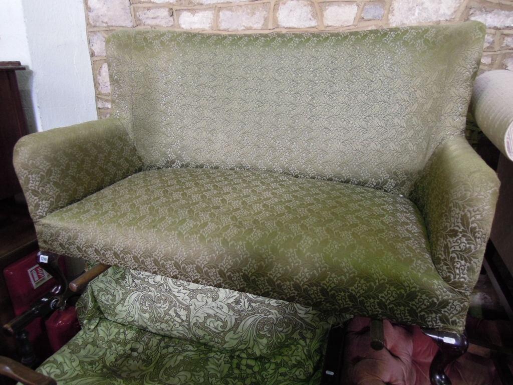 Appraisal: An Edwardian two seat sofa with shaped outline and green