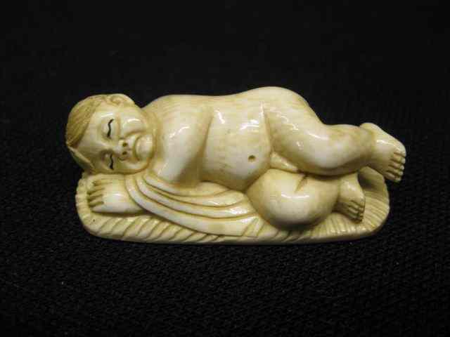 Appraisal: Carved Ivory Figurine of Baby Boy Asleep '' long excellent