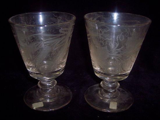 Appraisal: A pair of wine glasses with etched decoration cm high