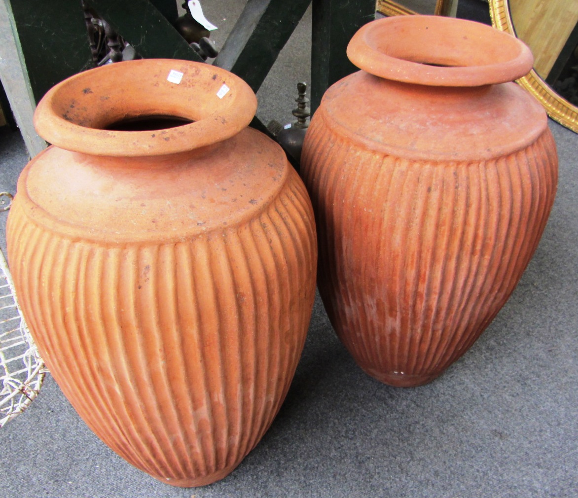 Appraisal: A pair of terracotta amphora olive jars th century cm