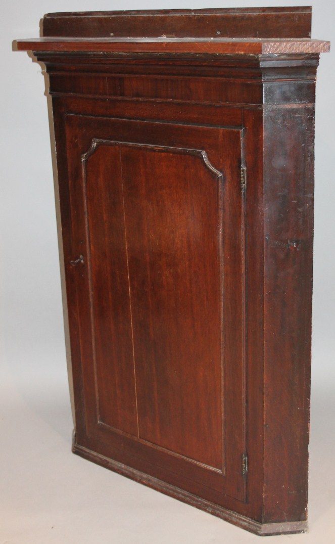 Appraisal: An thC oak hanging corner cupboard with a later over