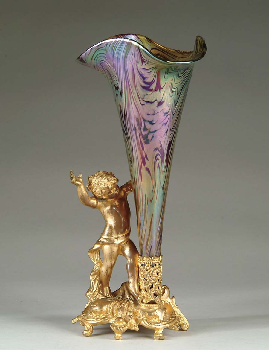 Appraisal: LOETZ TYPE VASE WITH METAL HOLDER Iridescent swirled decoration consisting