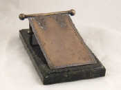 Appraisal: A Latvian assay silver note holder on a green marble