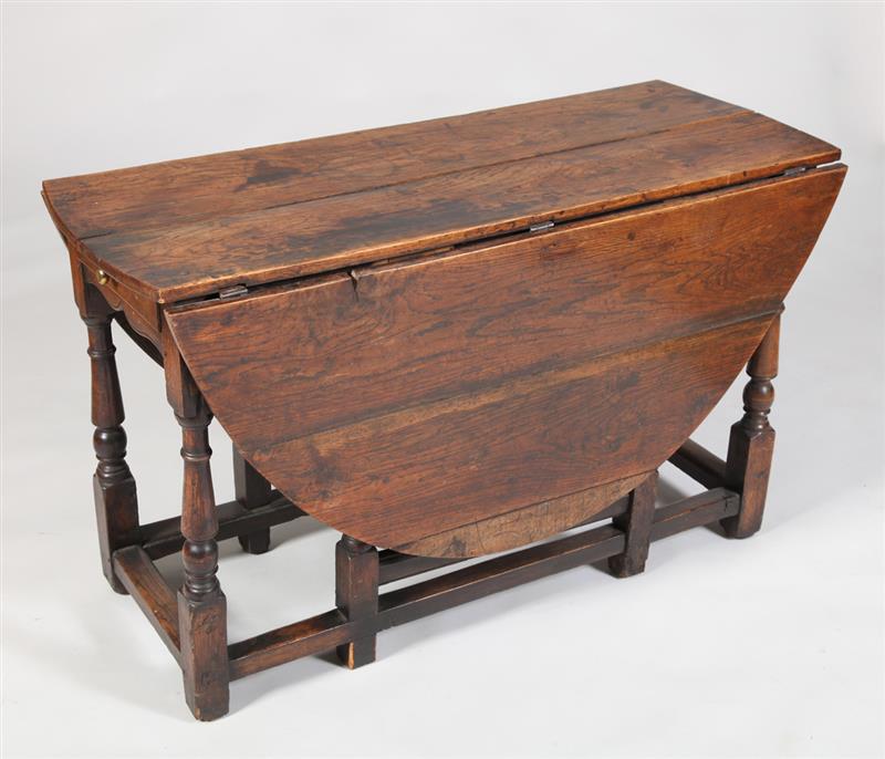 Appraisal: ENGLISH STAINED ELM GATE-LEG TABLE With drop-leaf sides fitted with