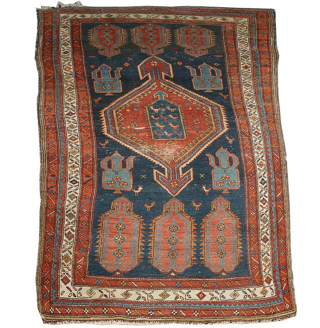 Appraisal: A CAUCASIAN DARK BLUE GROUND TRIBAL RUG with central medallion