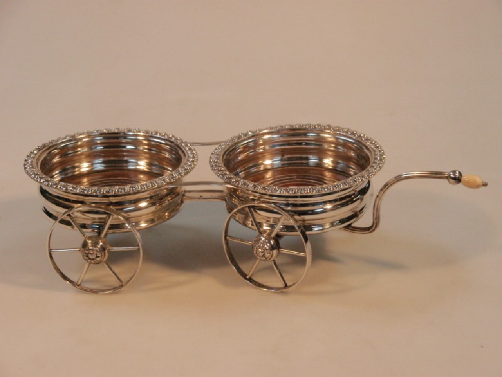 Appraisal: A thC silver plated double wine coaster table carriage with